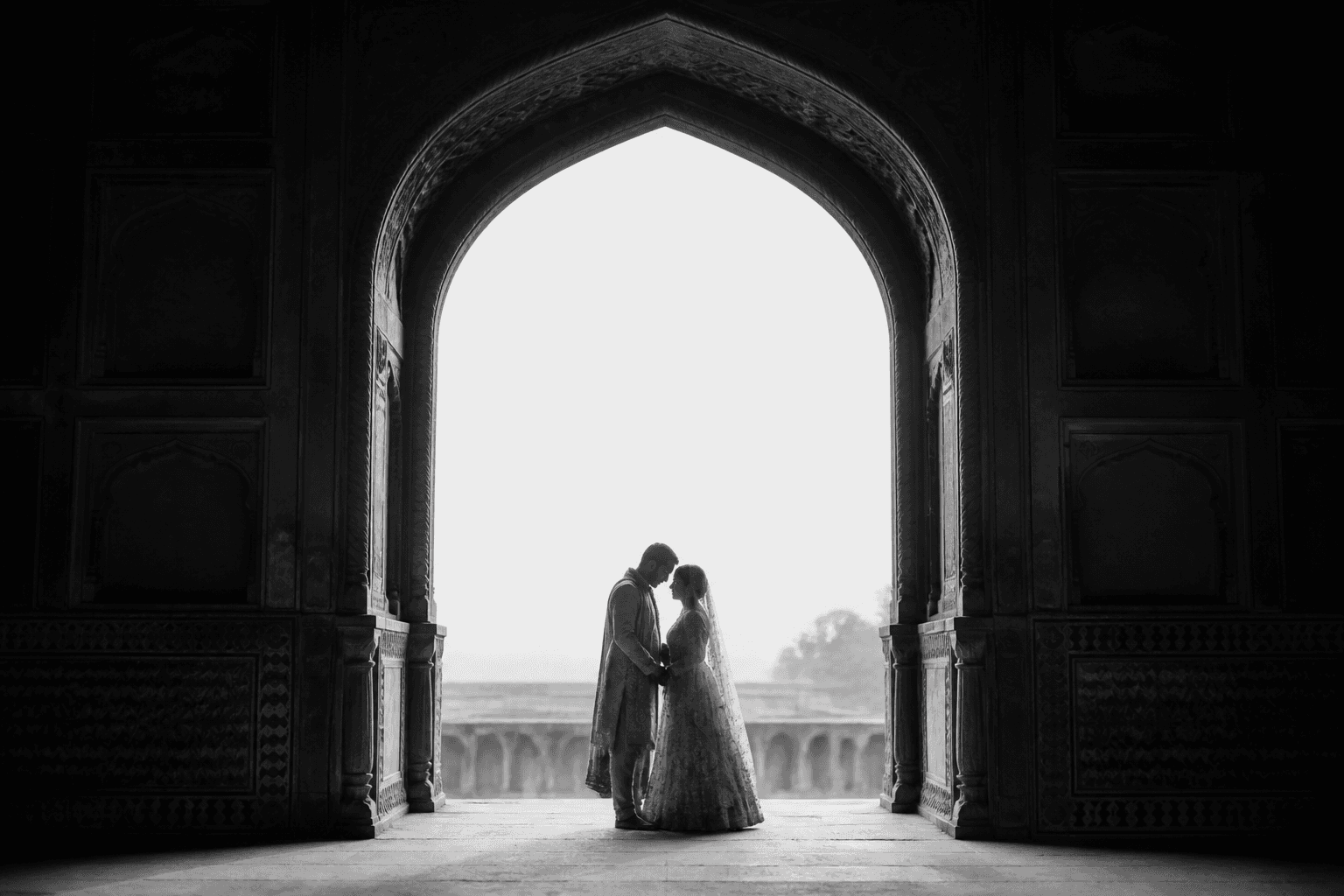 Wedding couple beneath a historic arch